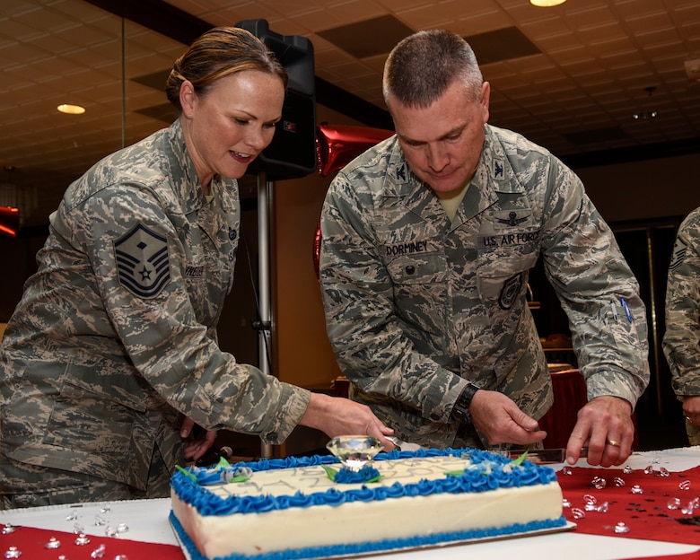 PETERSON AIR FORCE BASE, Colo. – Col. Eric Dorminey, 21st Space Wing vice commander, and Master Sgt. Candi Schneider, 21st Civil Engineer Squadron first sergeant, cut the Peterson Air Force Base birthday cake at The Club on Peterson Air Force Base, Colo., April 28, 2017. The Diamond Jubilee celebrated 75 years of existence for the base. (U.S. Air Force photo by Senior Airman Rose Gudex)
