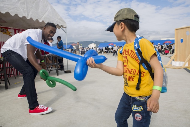 A Japanese local and a U.S. Marine use ballon swords to duel during the 41st Japan Maritime Self-Defense Force – Marine Corps Air Station Iwakuni Friendship Day at MCAS Iwakuni, Japan, May 5, 2017. Since 1973, MCAS Iwakuni has held a single-day air show designed to foster positive relationships and offer an elevating experience that displays the communal support between the U.S. and Japan. The air show also encompassed various U.S. and Japanese static aircraft displays, aerial performances and demonstrations, food and entertainment. (U.S. Marine Corps photo by Lance Cpl. Jesula Jeanlouis)