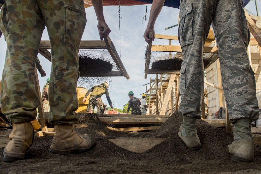 Australian soldiers and U.S. airmen screen sand for wall plaster while working on a classroom construction project at Margen Elementary School in Ormoc City, Philippines, April 29, 2017, as part of exercise Balikatan 2017. Air Force photo by Staff Sgt. Peter Reft