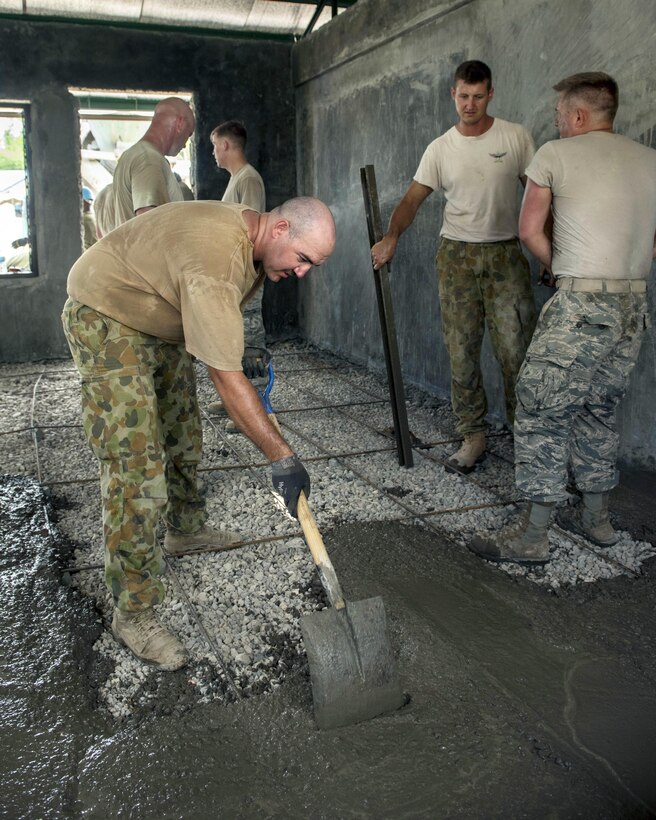 U.S. airmen and Australian soldiers pour concrete for a classroom floor at Margen Elementary School in Ormoc City, Philippines, April 29, 2017, as part of exercise Balikatan 2017. Air Force photo by Staff Sgt. Peter Reft