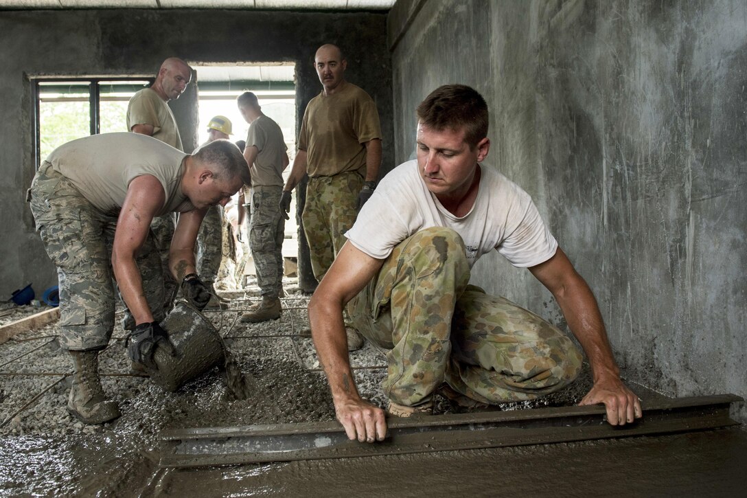U.S. airmen and Australian soldiers pour concrete for a classroom floor at Margen Elementary School in Ormoc City, Philippines, April 29, 2017, as part of exercise Balikatan 2017. Air Force photo by Staff Sgt. Peter Reft