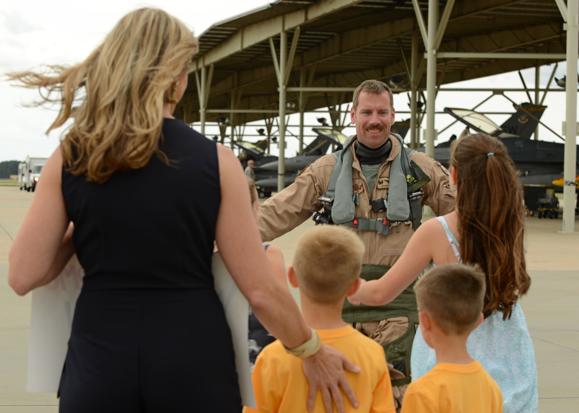 A U.S. Airman assigned to the 79th Fighter Squadron (FS) prepares to hug his family after returning to Shaw Air Force Base, S.C., May 4, 2017. The 79th FS is one of three 20th Fighter Wing F-16CM Fighting Falcon squadrons which supply suppression of enemy air defenses and combat-ready airpower. (U.S. Air Force Airman 1st Class Kathryn R.C. Reaves)