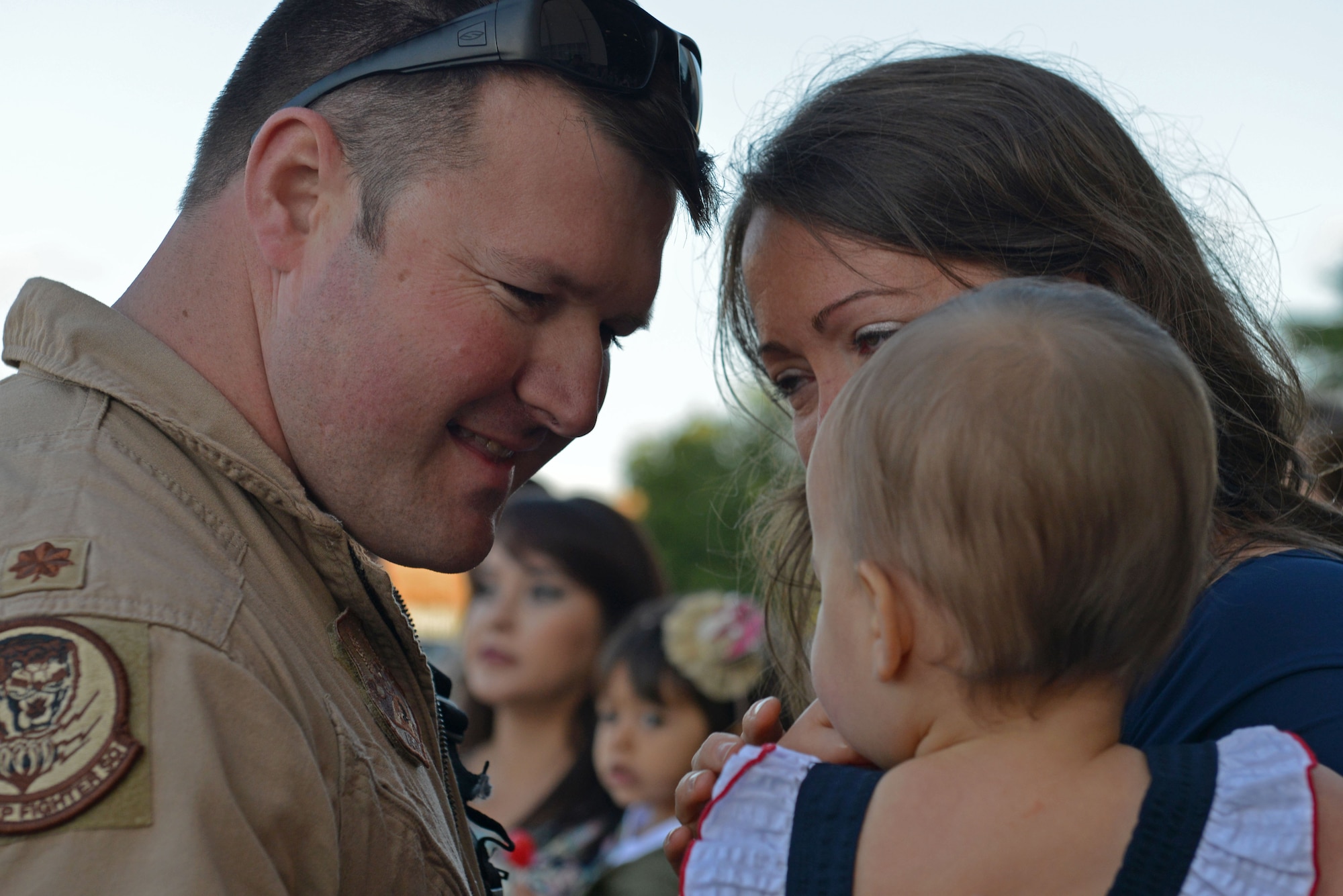 A U.S. Airman assigned to the 79th Fighter Squadron smiles at his child after returning to Shaw Air Force Base, S.C., May 5, 2017. Airmen returned after a six-month deployment to the United States Central Command area of responsibility. (U.S. Air Force photo by Airman 1st Class Destinee Sweeney)