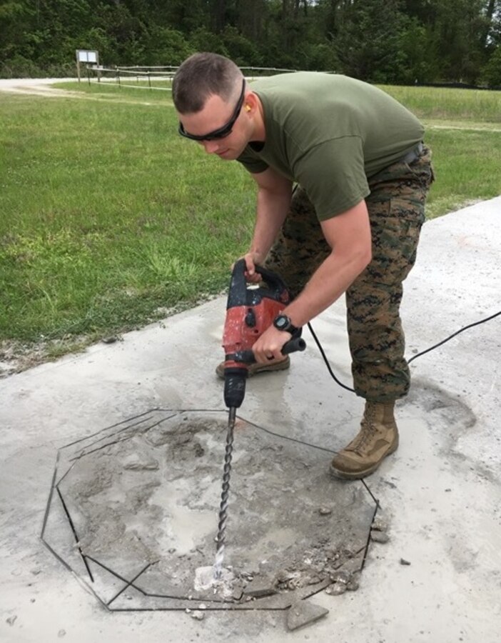 On April 19, 2017 Second Lieutenant Ryan Christmas, a Marine attached to Combat Engineer Officer course 4-17 (CEO 4-17); removes the uneven corners of a spall with a concrete drill.  CEO students learn how to repair spalls and crater damage on an airfield utilizing tools from the Airfield Damage Repair kit at Marine Corps Engineer School aboard Courthouse Bay, Camp Lejeune, N.C.
