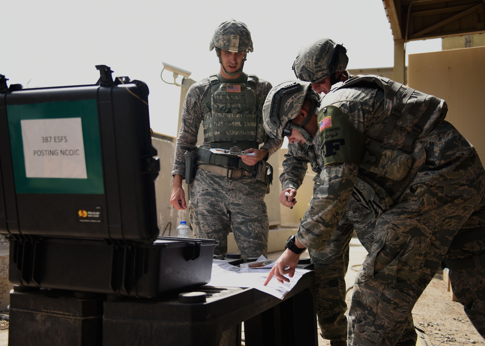 Several 387th Expeditionary Security Forces response team members discuss postings for personnel during a force protection condition delta exercise at an undisclosed location in Southwest Asia, April 27, 2017. The 387th Air Expeditionary Group conducted a force protection condition delta exercise to demonstrate base defense capabilities in response to increased terrorist threat levels. (U.S. Air Force photo/ Tech. Sgt. Jonathan Hehnly)