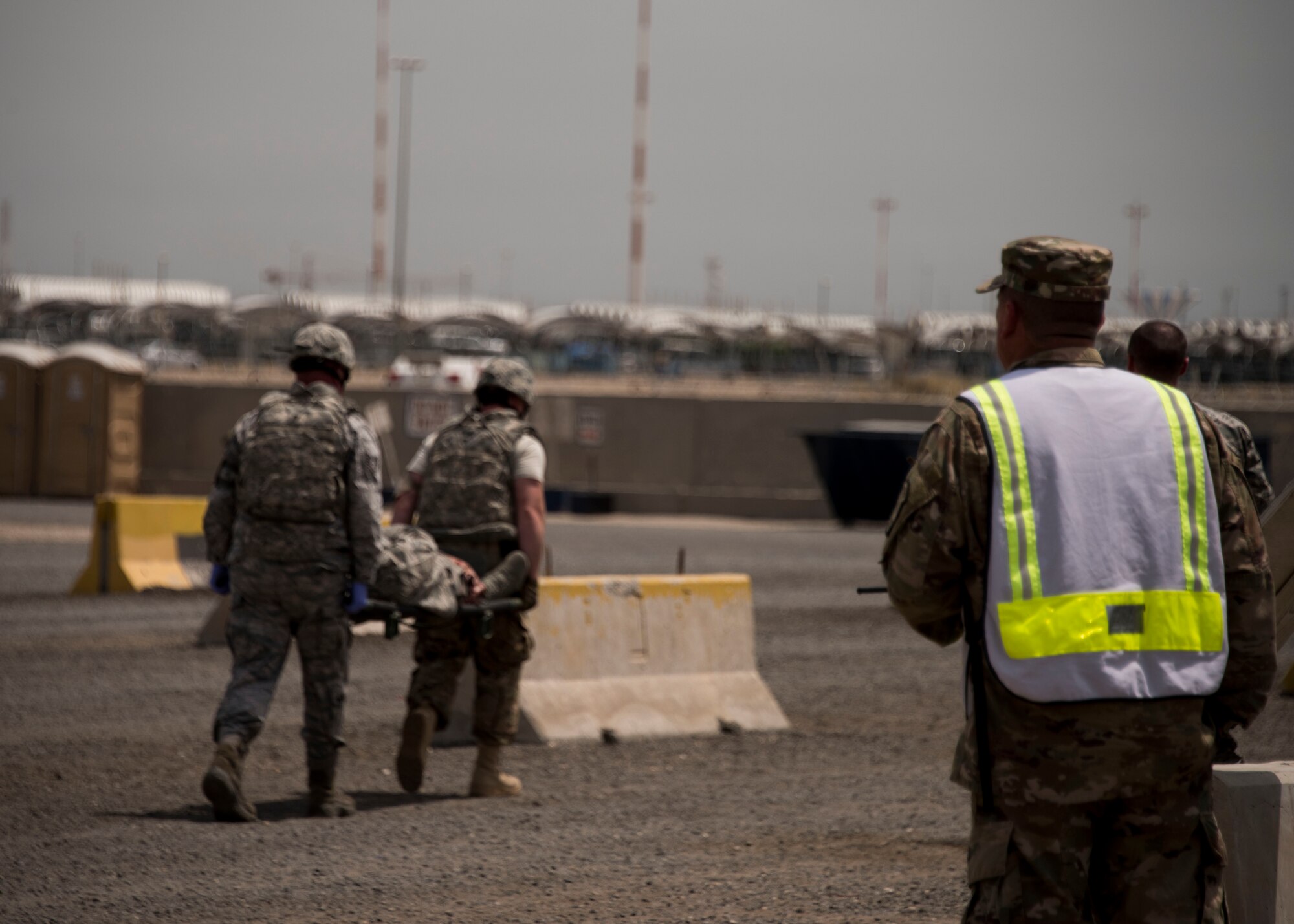 Members of the 387th Expeditionary Security Forces Squadron evacuate a simulated casualty after a vehicle borne improvised explosive device detonation as a wing inspection team member evaluates them during a force protection condition delta exercise at an undisclosed location in Southwest Asia, April 27, 2017. The 387th Air Expeditionary Group conducted a force protection condition delta exercise to demonstrate base defense capabilities in response to increased terrorist threat levels. (U.S. Air Force photo/ Tech. Sgt. Jonathan Hehnly)