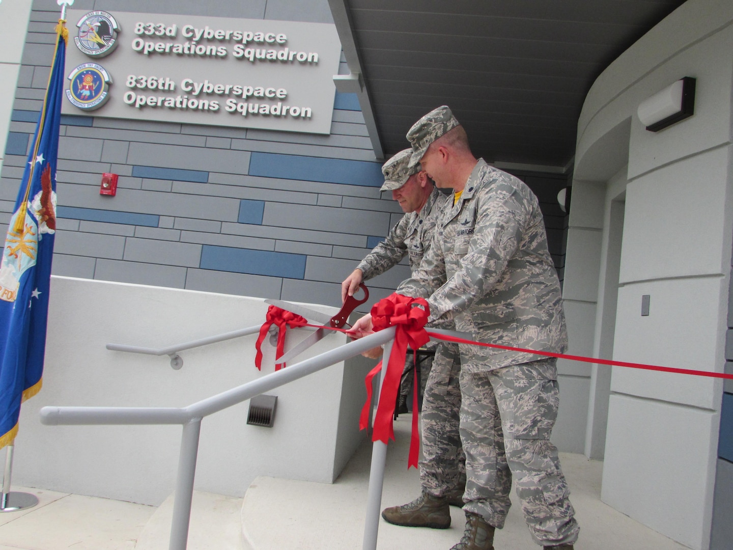 Lt. Col. Jarrod Norris, 836th Cyberspace Operations Squadron Commander, and Lt. Colonel Travis Howell, 833rd COS Commander, cut the ribbon for the newly-renovated Building 390 April 14 on Medina Annex, San Antonio, Texas. The new 836/833 COS headquarters is the first building in the Air Force solely dedicated to cyber mission forces. (Courtesy photo)
