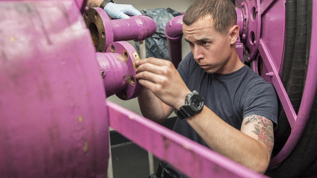 Navy Petty Officer 3rd Class Jordet James replaces an amphenol stud on a hose reel aboard the aircraft carrier USS Ronald Reagan near Yokosuka, Japan, May 4, 2017. An amphenol stud serves to ensure electrical continuity between the hose reel and ship's power. The Ronald Reagan is the flagship of Carrier Strike Group 5, which protects and defends allies and partners in the Indo-Asia-Pacific region. Navy photo by Petty Officer 2nd Class Jamal McNeill