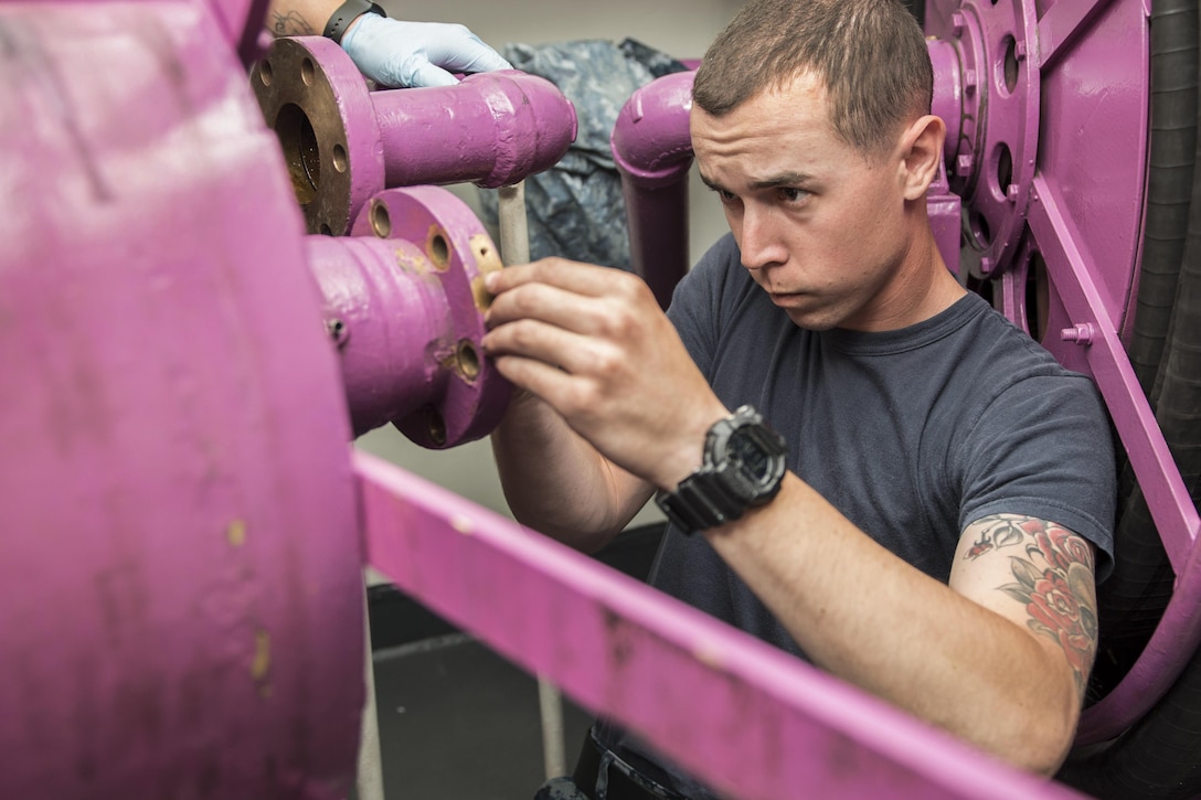 Navy Petty Officer 3rd Class Jordet James replaces an amphenol stud on a hose reel aboard the aircraft carrier USS Ronald Reagan near Yokosuka, Japan, May 4, 2017. An amphenol stud serves to ensure electrical continuity between the hose reel and ship's power. The Ronald Reagan is the flagship of Carrier Strike Group 5, which protects and defends allies and partners in the Indo-Asia-Pacific region. Navy photo by Petty Officer 2nd Class Jamal McNeill