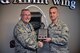 Col. Jonathan M. Philebaum, commander, 932nd Airlift Wing, takes time during the Wing Review meeting May 5, 2017 to honor and present Senior Airman Travis J. Biggers the Commandant Award plaque Biggers earned for demonstrating leadership and military professionalism  while attending the Chief Master Sergeant of the Air Force Bud Andrews Airman Leadership School Scott Air Force Base, Illinois. 