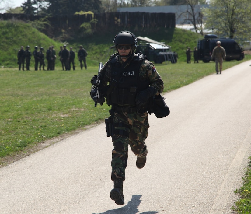 A Serbian special anti-terrorist unit officer runs to the first station of a shooting exercise during joint  combined exchange training with U.S. and Slovenian special operation forces at the SAJ headquarters complex in Serbia, April 10, 2017. The Serbian unit, known as the SAJ, serves as a special operations and tactical unit of the Serbian police and will receive training in a variety of tactics and techniques over the course of the JCET to increase their effectiveness in future operations. Army photo by Spc. Simeon Trombitus