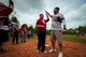 Matthew Thompson, Ramstein High School student, gives U.S. Army Chief Warrant Officer Patrick Waltman, European Guzzlers softball player, a high five during the Adaptive Sports softball game at Donnelly Park on Ramstein Air Base, Germany, May 4, 2017. The Guzzlers came out to the event to support and cheer on the special-needs students. (U.S. Air Force photo by Senior Airman Devin Boyer/Released)