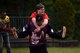 Nick Waller, European Guzzlers softball player, carries James Lucas, Kaiserslautern Middle School student, while running two second base during the Adaptive Sports softball game at Donnelly Park on Ramstein Air Base, Germany, May 4, 2017. The Guzzlers helped the special-needs students during the game as part of the Adaptive Sports program. (U.S. Air Force photo by Senior Airman Devin Boyer/Released)