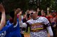 U.S. Army Chief Warrant Officer Patrick Waltman, European Guzzlers softball player, high fives students after the Adaptive Sports softball game at Donnelly Park on Ramstein Air Base, Germany, May 4, 2017. As part of tradition, opposing teams will slap hands and exchange the words “good game” to show respect and good sportsmanship. (U.S. Air Force photo by Senior Airman Devin Boyer/Released)