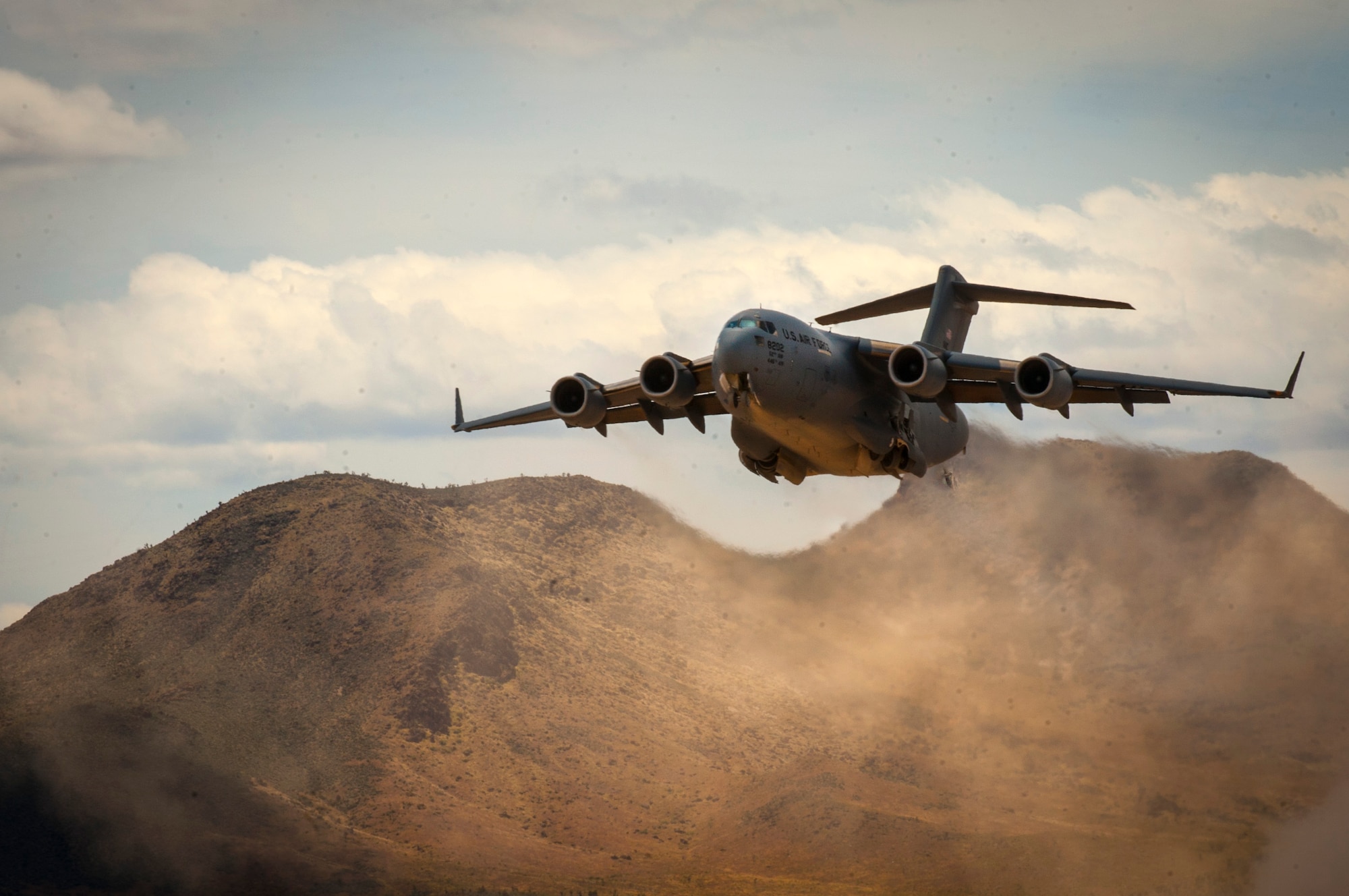 A C-17 Globemaster III cargo aircraft assigned to the 57th Weapons Squadron, U.S. Air Force Weapons School, Nellis Air Force Base, Nev., takes off from a dry lake bed during a composite mission application exercise at the Nevada Test and Training Range, April 24, 2017. The training scenario required an aeromedical evacuation of a combat casualty via a C-17. (U.S. Air Force photo by Senior Airman Joshua Kleinholz/Released)