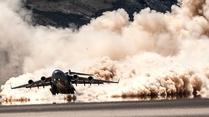 A C-17 Globemaster III cargo aircraft, assigned to the 57th Weapons Squadron, U.S. Air Force Weapons School, Nellis Air Force Base, Nev., takes off from a dry lake bed during a composite mission application exercise on the Nevada Test and Training Range. Several U.S. Air Force aircraft can operate in austere conditions, allowing for rapid medical evacuations and the establishment of improvised forward refueling points. (U.S. Air Force photo by Senior Airman Joshua Kleinholz/Released)