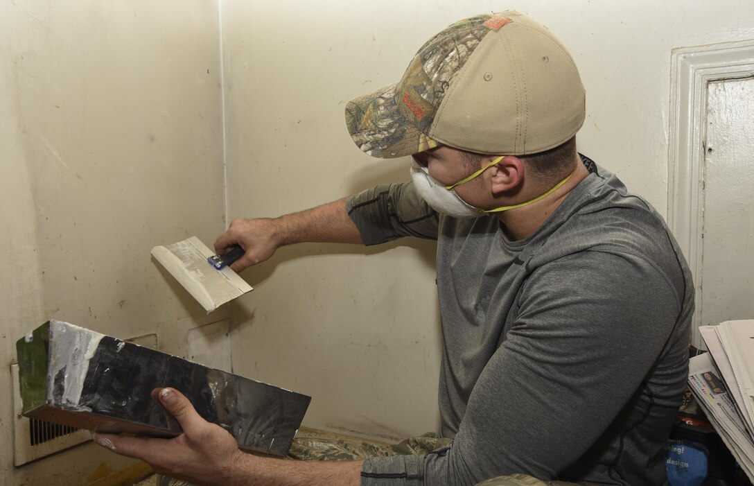 Senior Airman Merrit Metzler, 11th Civil Engineer Squadron structures journeyman, repairs a hole in a wall at a house in College Park, Md., April 29, 2017. More than 20 Joint Base Andrews 11th CES Airmen partook in the 2017 Christmas in April Prince George’s County, an annual volunteer program that repairs the homes of low-income or physically challenged senior citizens in one day. The renovations included electrical, plumbing and structural repairs. (U.S. Air Force photo by Airman 1st Class Rustie Kramer)