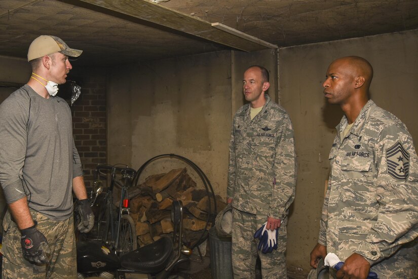 Senior Airman Merritt Metzler, left, 11th Civil Engineer Squadron structures journeyman, briefs Col. E. John Teichert, 11th Wing and Joint Base Andrews commander, and Chief Master Sgt. Nathaniel Perry, 11th WG and JBA command chief, on planned renovations during a Prince George’s County Christmas in April project in College Park, Md., April 29, 2017. More than 20 Joint Base Andrews 11th CES Airmen partook in the 2017 Christmas in April Prince George’s County, an annual volunteer program that repairs the homes of low-income or physically challenged senior citizens in one day. The renovations included electrical, plumbing and structural repairs. (U.S. Air Force photo by Airman 1st Class Rustie Kramer)