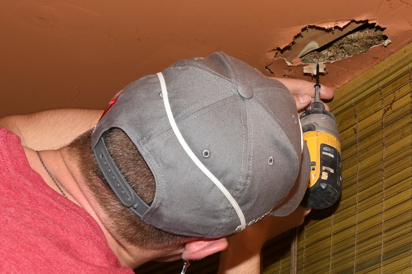 Airman 1st Class Hogan Lambeth, 11th Civil Engineer Squadron structures apprentice, drills into a ceiling during a volunteer event in College Park, Md., April 29, 2017. More than 20 Joint Base Andrews 11th CES Airmen partook in the 2017 Christmas in April Prince George’s County, an annual volunteer program that repairs the homes of low-income or physically challenged senior citizens in one day. The renovations included electrical, plumbing and structural repairs. (U.S. Air Force photo by Airman 1st Class Rustie Kramer)