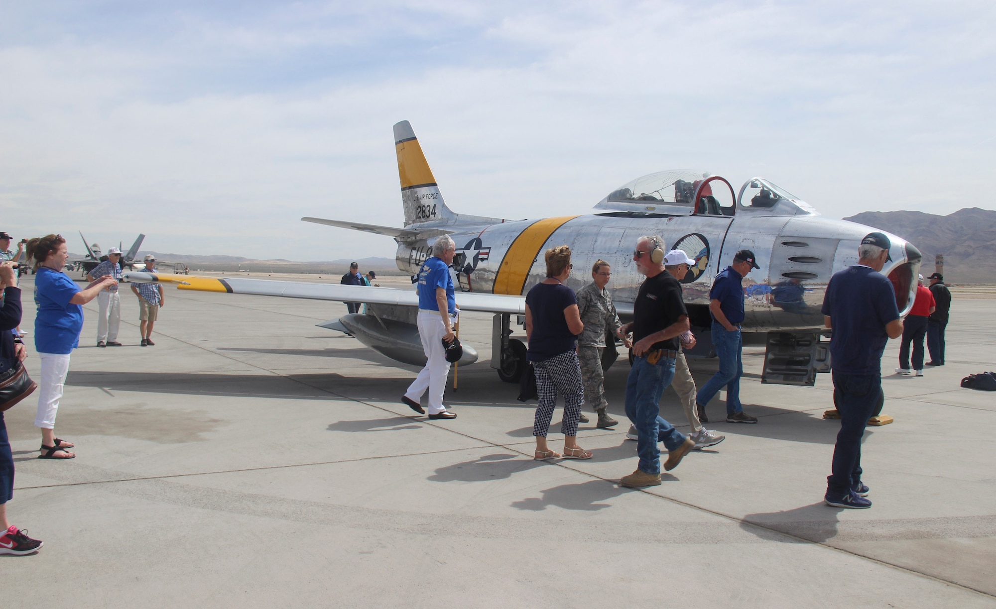 Members of the F-86 Sabre Association view an F-86 Sabre during the group’s last reunion on the flightline at Nellis Air Force Base, Nev., April 24, 2017. The F-86 Sabre was originally designed as a high-altitude fighter, making it highly valued during the Korean War. (U.S. Air Force photo by Susan Garcia/Released) 