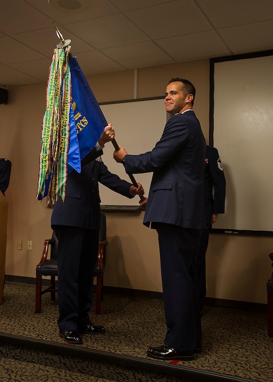 Lt. Col. John Robinson, 315th Operations Group commander, passes the 4th Combat Camera Squadron colors to Maj. Hamilton Underwood, the new 4th CTCS commander, during a unit reactivation and assumption of command ceremony at Joint Base Charleston, S.C., May 5. The 4th CTCS, which was formally assigned to March Air Reserve Base in Riverside, Calif., deactivated in July 2015, but was reactivated and relocated to the 315 AW due to mission need. (U.S.Air Force Photo by Michael Dukes)
