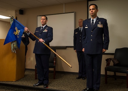 (from left) Lt. Col. John Robinson, 315th Operations Group commander, holds the 4th Combat Camera Squadron colors and declares the unit officially reactivated prior to Maj. Hamilton Underwood, assuming command of the squadron during a unit reactivation and assumption of command ceremony at Joint Base Charleston, S.C., May 5. The 4th CTCS, which was formally assigned to March Air Reserve Base in Riverside, Calif., deactivated in July 2015, but was reactivated and relocated to the 315 AW due to mission need. (U.S.Air Force Photo by Michael Dukes)