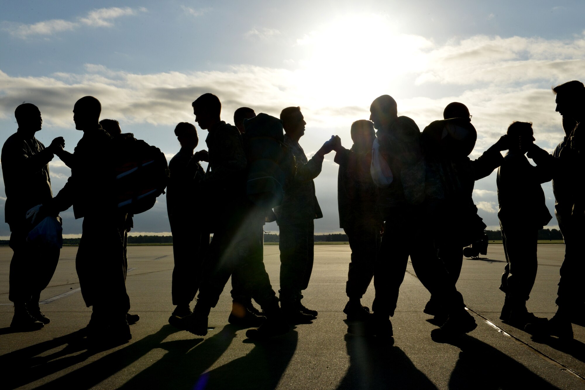 U.S. Airmen assigned to the 20th Fighter Wing fist-bump Team Shaw leadership after landing at Shaw Air Force Base, S.C., May 5, 2017. Airmen returned after a six-month deployment to the United States Central Command area of responsibility. (U.S. Air Force photo by Airman 1st Class Destinee Sweeney)