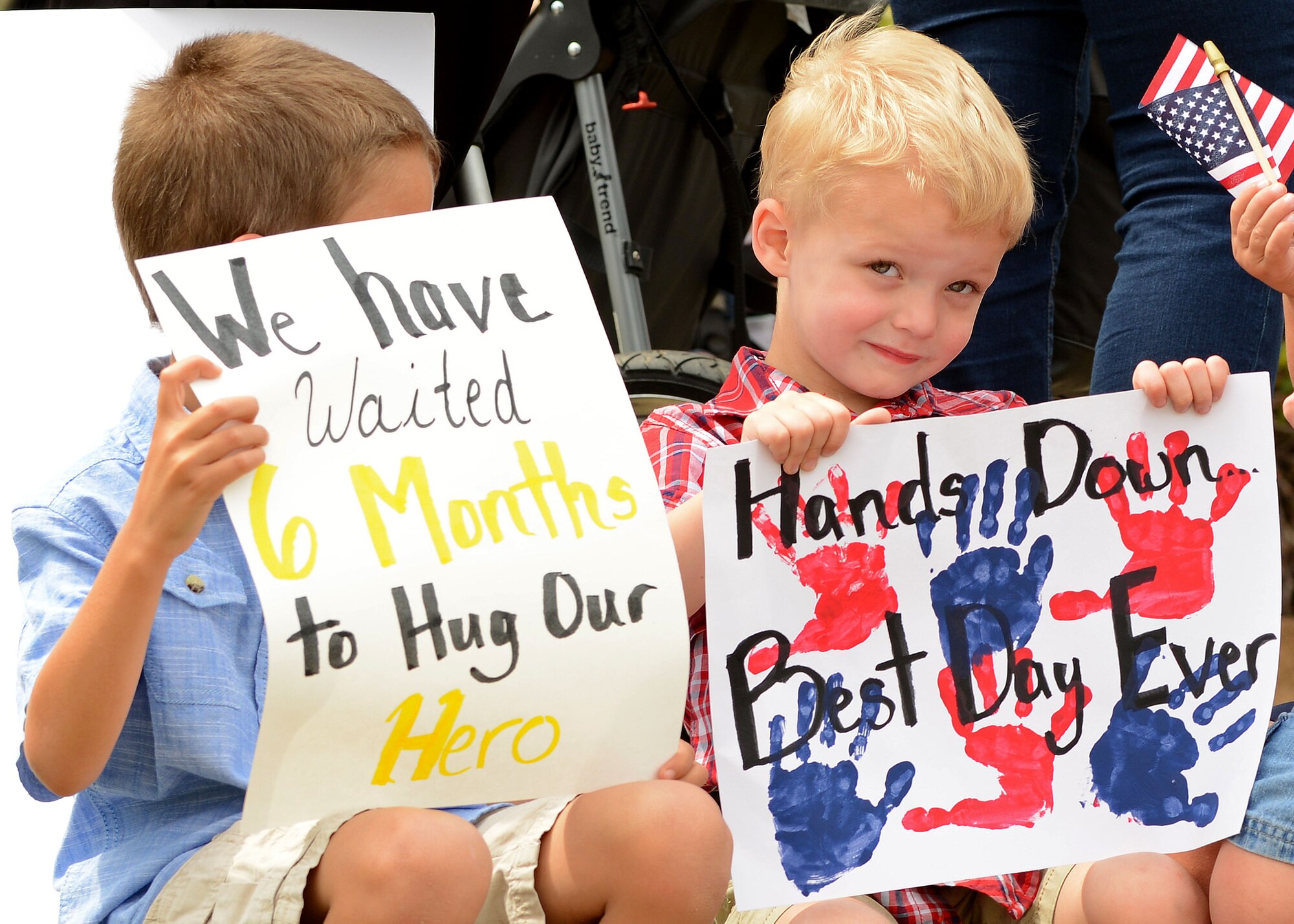 Team Shaw children wait outside the 79th Aircraft Maintenance Unit building for their loved ones to return home to Shaw Air Force Base, S.C., May 4, 2017. Their Airmen returned from Bagram Airfield, Afghanistan, after a six-month deployment in support of Operation Freedom’s Sentinel. (U.S. Air Force photo by Airman 1st Class Kathryn R.C. Reaves)