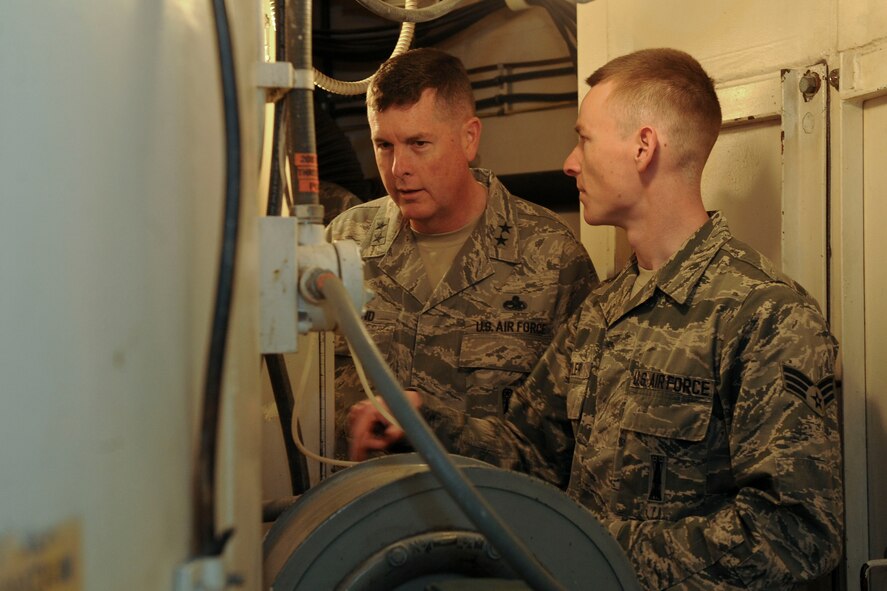 Senior Airman Jamie Oyler, 91st Missile Maintenance Squadron facilities maintenance team team chief, explains launch tube temperature to Maj. Gen. Gene Kirkland, Air Force Material Command director of logistics, civil engineering and force protection, at Minot Air Force Base, N.D., Apr. 28, 2017. Kirkland visited to discuss logistics with 5th Bomb Wing and 91st Missile Wing Airmen and speak at the 91st Maintenance Group Maintenance Professional of the Year banquet. (U.S. Air Force photo/Airman 1st Class Jessica Weissman)