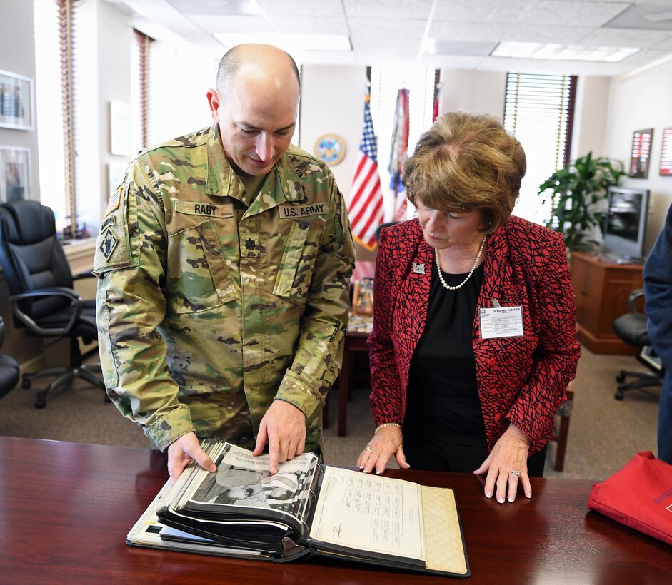 U.S. Army Corps of Engineers, Mobile District, Deputy Commander Lt. Col. Landon Raby presents a book to Barbara R. McLauchlin, the daughter of Maj. Gen. Daniel A. Raymond, April 20. Raymond himself put the book together of key milestones of the district during his command here from 1961-1964. (Photo by Tim Oberle)