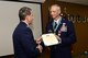 120th Airlift Wing Vice Commander Col. Thomas Mora presents Col. Patrick Hover with his retirement papers signed by President Donald Trump during his retirement ceremony held at the 120th AW in Great Falls, Mont. April 28, 2017. Hover last served as the commander of the 120th Operations Group. (U.S. Air National Guard photo by Senior Master Sgt. Eric Peterson)