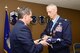 120th Airlift Wing Vice Commander Col. Thomas Mora presents Col. Patrick Hover with a flag folded by members of the Montana Air National Guard Honor Guard during his retirement ceremony held at the 120th AW in Great Falls, Mont. April 28, 2017. The flag had been with Hover since his pilot training and was originally used in a ceremony for a friend who had died in an F-16 accident. Hover last served as the commander of the 120th Operations Group. (U.S. Air National Guard photo by Senior Master Sgt. Eric Peterson)