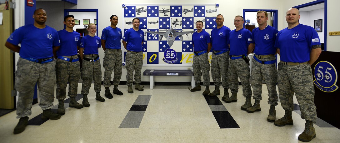 U.S. Airmen assigned to the 20th Aircraft Maintenance Squadron, 55th Aircraft Maintenance Unit (AMU,) pose next to a 100th anniversary mural in the 55th AMU building at Shaw Air Force Base, S.C., April 28, 2017. The mural commemorates a century of accomplishments since the 55th Fighter Squadron’s creation in 1917. (U.S. Air Force photo by Senior Airman Kelsey Tucker)