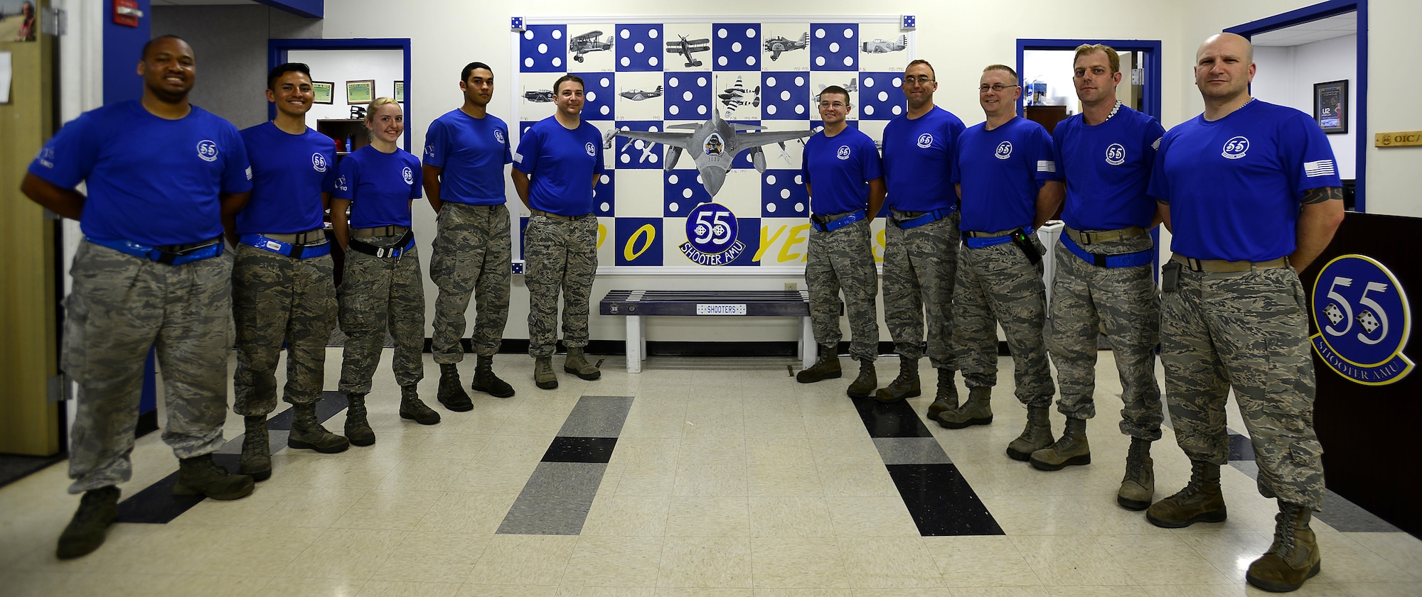 U.S. Airmen assigned to the 20th Aircraft Maintenance Squadron, 55th Aircraft Maintenance Unit (AMU,) pose next to a 100th anniversary mural in the 55th AMU building at Shaw Air Force Base, S.C., April 28, 2017. The mural commemorates a century of accomplishments since the 55th Fighter Squadron’s creation in 1917. (U.S. Air Force photo by Senior Airman Kelsey Tucker)