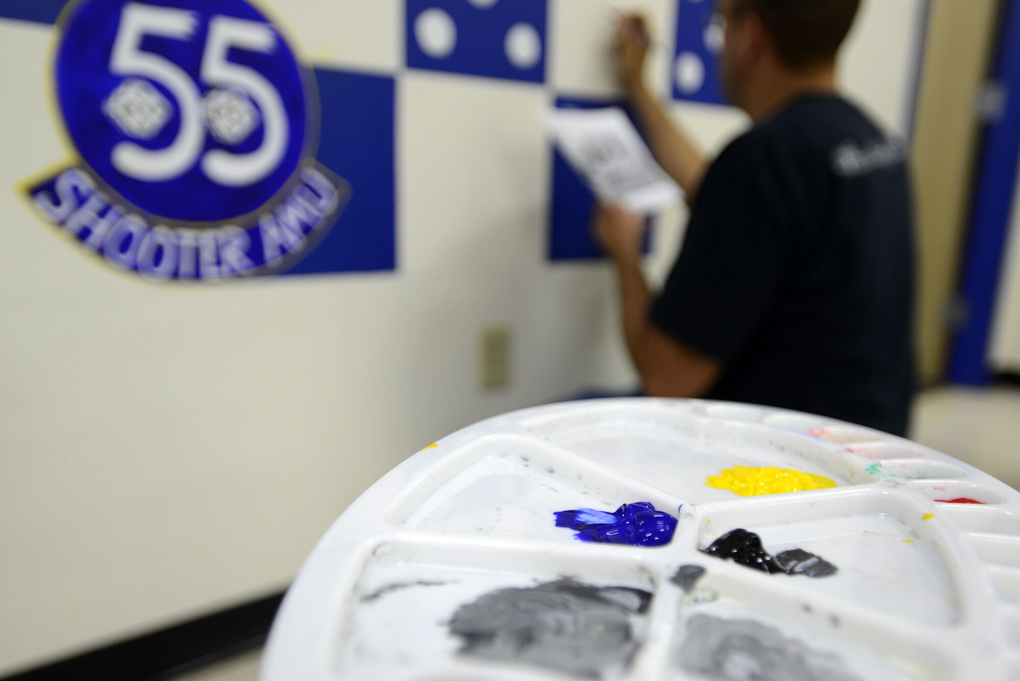 U.S. Air Force Tech. Sgt. Brian Barnes, 20th Aircraft Maintenance Squadron, 55th Aircraft Maintenance Unit (AMU) tactical aircraft maintainer, sketches the outline of an A-10 Thunderbolt II on a mural in the 55th AMU at Shaw Air Force Base, S.C., Feb. 10, 2017. The mural was created in honor of the 55th Fighter Squadron’s 100th anniversary on Aug. 9. (U.S. Air Force photo by Airman 1st Class Kelsey Tucker)