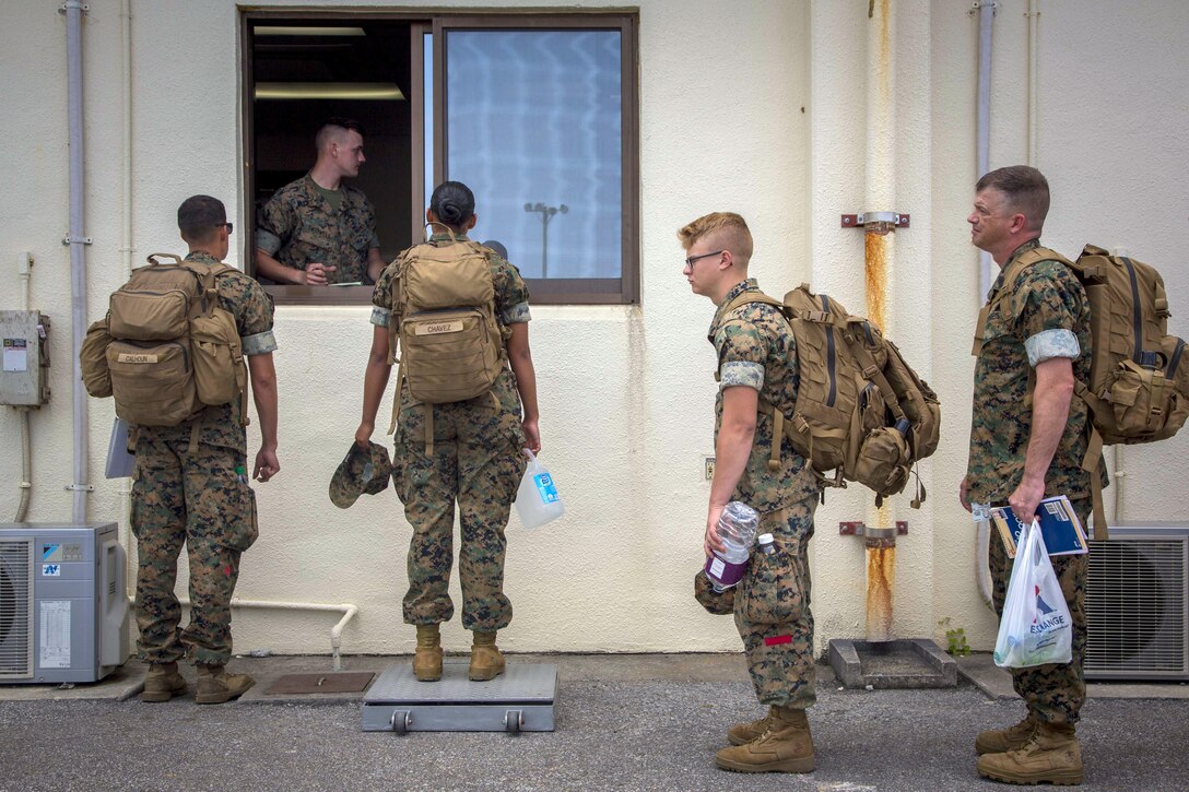 Marines stand in line to have their weigh taking during an Alert Contingency Marine Air-Ground Task Force drill at Kadena Air Base in Okinawa, Japan, May 5, 2017. Marine Corps photo by Lance Cpl. Juan C. Bustos