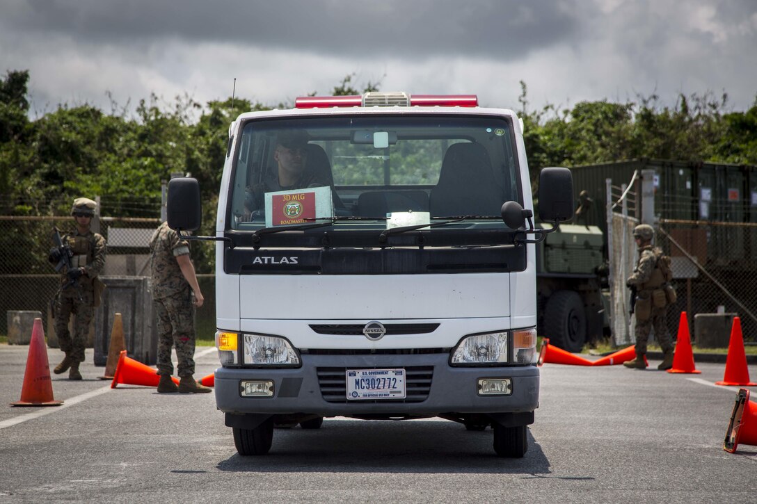 A Marine drives through an entry point during an Alert Contingency Marine Air-Ground Task Force drill at Kadena Air Base in Okinawa, Japan, May 5, 2017. Marine Corps photo by Lance Cpl. Juan C. Bustos