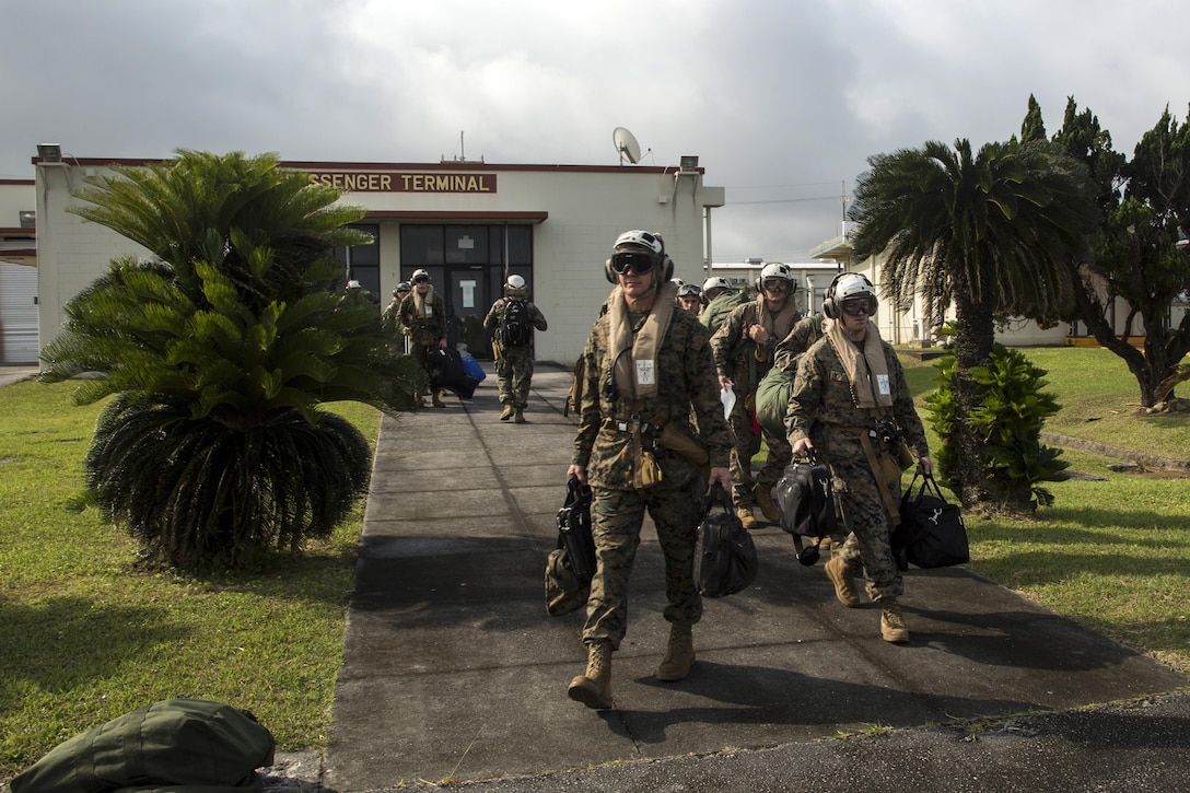 Marines prepare to board a MV-22 Osprey at Marine Corps Air Station Futenma in Okinawa, Japan, May 5, 2017, to conduct an Alert Contingency Marine Air-Ground Task Force drill. Marine Corps photo by Cpl. Allison M. Lotz