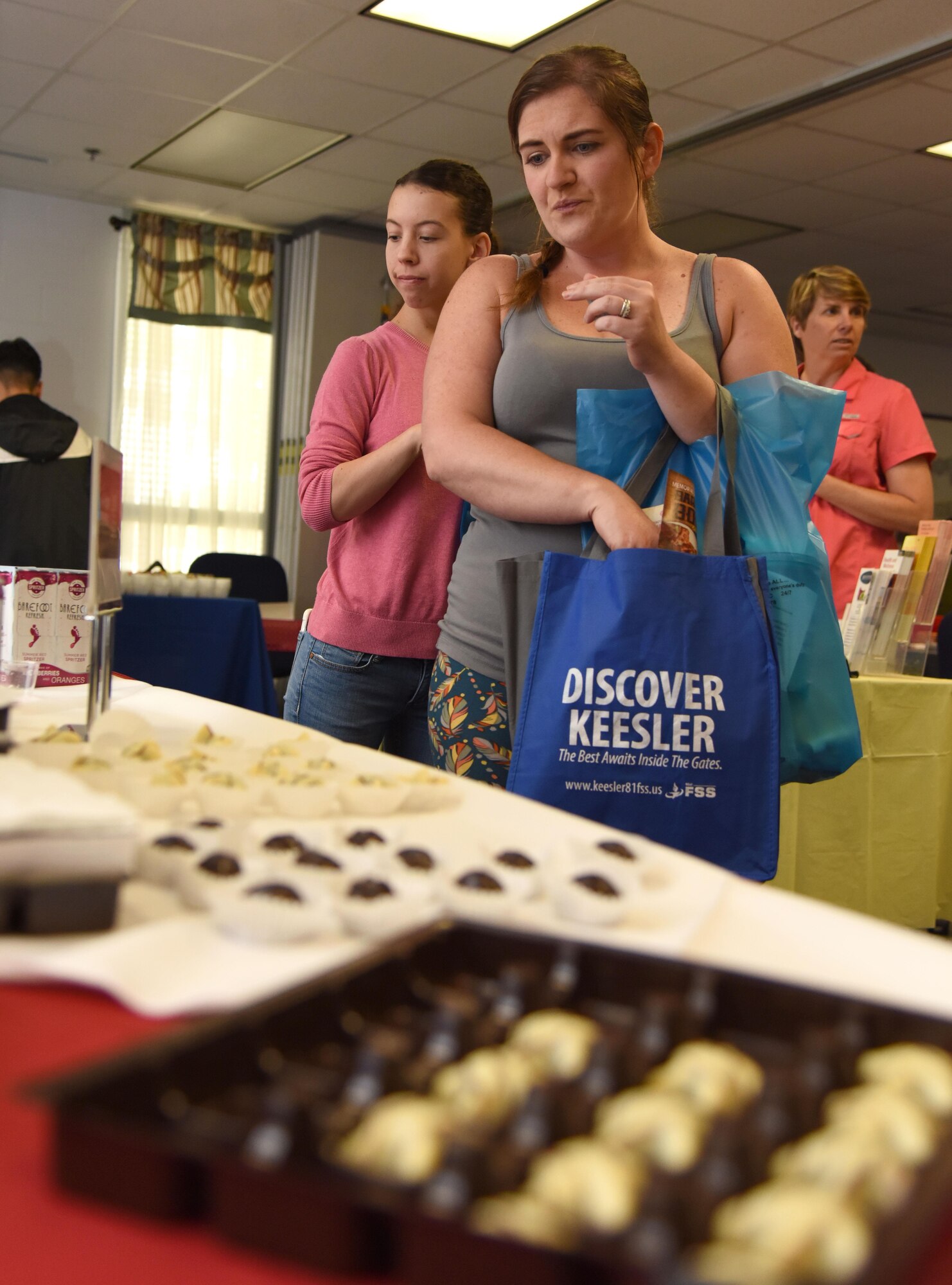 Kayla Dessormeau, spouse of Airman Basic Andrew Dessormeau, 338th Training Squadron student, and Melissa Stip, spouse of Airman 1st Class Scott Stip, 338th TRS student, view chocolate samples during Pamper Me Day at the Sablich Center May 4, 2017, on Keesler Air Force Base, Miss. Keesler’s Airman and Family Readiness Center has hosted the event for the past 13 years, offering spouses free manicures, make-up styling tips and information and business booths. (U.S. Air Force photo by Kemberly Groue)