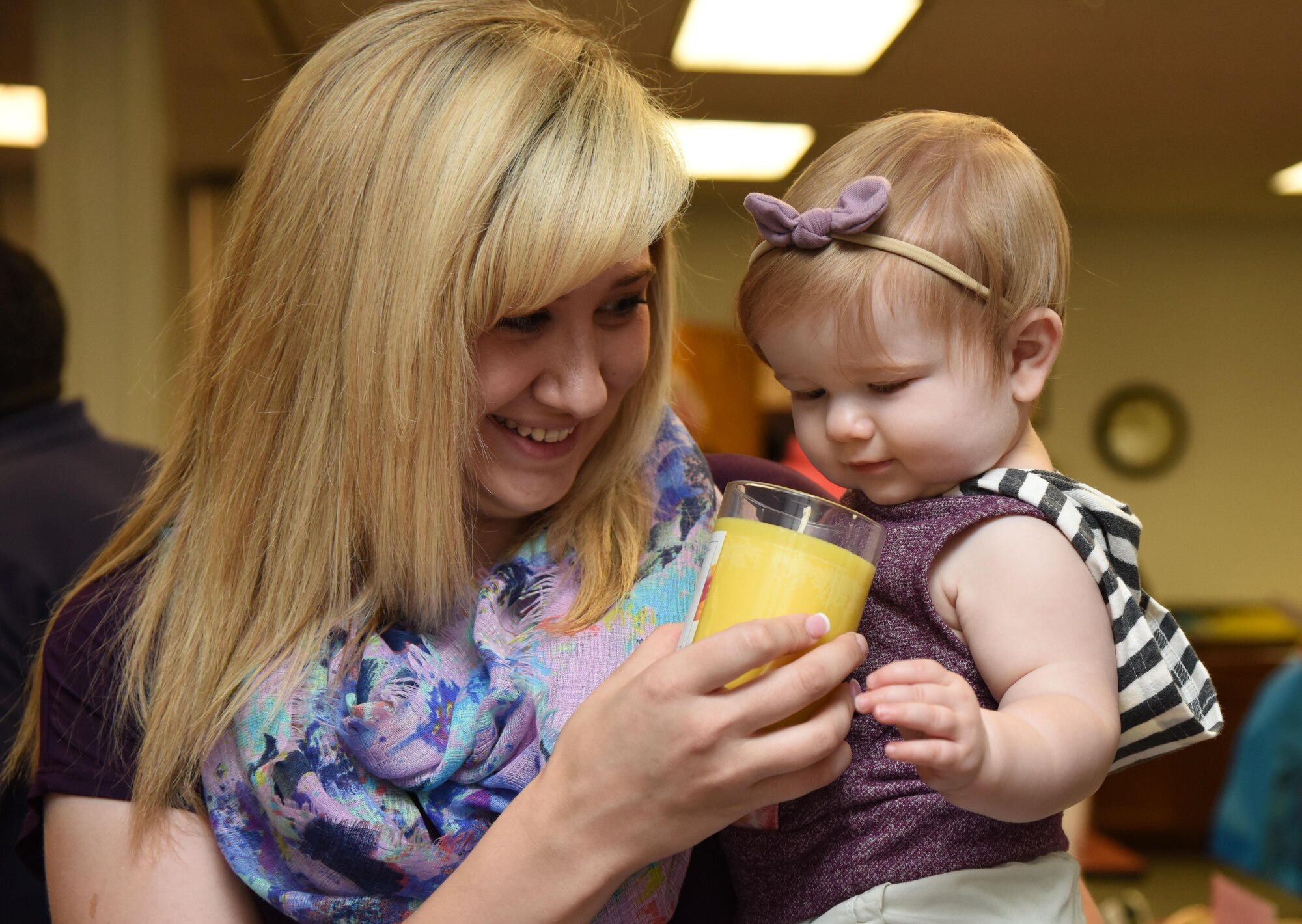 Melissa Davis, spouse of Airman Daniel Davis, 336th Training Squadron student, holds a candle to her daughter, Presley, to smell during Pamper Me Day at the Sablich Center May 4, 2017, on Keesler Air Force Base, Miss. Keesler’s Airman and Family Readiness Center has hosted the event for the past 13 years, offering spouses free manicures, make-up styling tips and information and business booths. (U.S. Air Force photo by Kemberly Groue)
