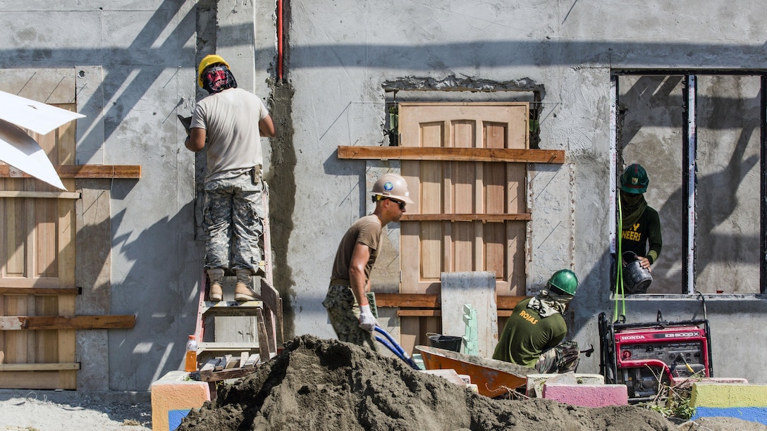U.S. and Philippine service members build a classroom at Malitbog Elementary School in Tapaz, Philippines, May 1, 2017, as part of a humanitarian civic action project for exercise Balikatan 2017. The U.S. troops are assigned to Naval Mobile Construction Battalion 3 and the 230th Engineer Company, Hawaii Army National Guard. Marine Corps photo by Lance Cpl. Nelson Duenas