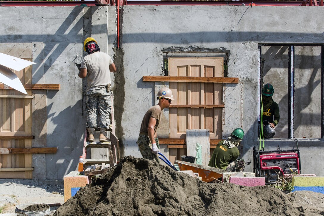 U.S. and Philippine service members build a classroom at Malitbog Elementary School in Tapaz, Philippines, May 1, 2017, as part of a humanitarian civic action project for exercise Balikatan 2017. The U.S. troops are assigned to Naval Mobile Construction Battalion 3 and the 230th Engineer Company, Hawaii Army National Guard. Marine Corps photo by Lance Cpl. Nelson Duenas