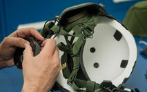 A member of the 54th Helicopter Squadron aircrew flight equipment section, installs ear protection on a helmet at Minot Air Force Base, N.D., May 2, 2017. The unit’s maintainers perform aircraft maintenance as well as inspect and manage various pieces of aircrew flight equipment. (U.S. Air Force photo/Airman 1st Class Jonathan McElderry)