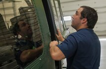 Thomas Martinez, 54th Helicopter Squadron aircraft mechanic, closes a helicopter cabin door at Minot Air Force Base, N.D., May 2, 2017. Squadron members also engage in emergency search and rescue mission training. (U.S. Air Force photo/Airman 1st Class Jonathan McElderry)
