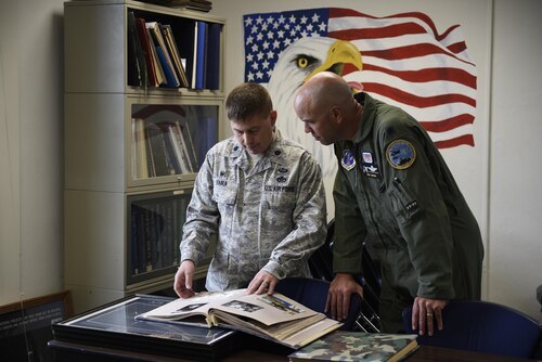 Lt. Col. Rusty Vaira, 219th Rapid Engineer Deployable Heavy Operational Repair Squadron Engineer, or RED HORSE Squadron commander, and Lt. Col Larry Gardner, 120th Airlift Wing Operations Support Squadron commander, flip through albums at the Air Force Reserves Officers’ Training Corps detachment 450 Montana State University, Bozeman April 24, 2017 in the ROTC classroom. Vaira, a graduate of Det. 450 was asked to speak to the cadets on his career path and had a chance to reminice about his beginnings in the detachment. (U.S. Air National Guard photo by Staff Sgt. Lindsey Soulsby)