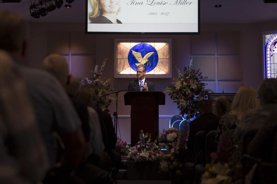 Mark Miller, husband of Tina Miller, former deputy, Combat Center Performance and Innovation Office, addresses friends and family during a celebration of life at Valley Community Chapel in Yucca Valley, Calif., in honor of Tina, April 29, 2017. (U.S. Marine Corps photo by Cpl. Thomas Mudd)