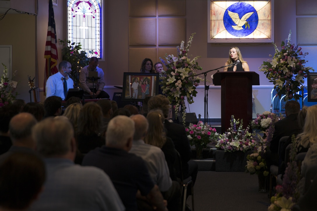 Valerie Kimball, daughter of Tina Miller, former deputy, Combat Center Performance and Innovation Office, talks about the lessons she learned from her mother during a celebration of life held at Valley Community Chapel in Yucca Valley, Calif., in honor of Tina, April 29, 2017. (U.S. Marine Corps photo by Cpl. Thomas Mudd)