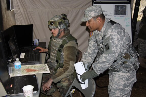 Capt. Anselmo Lizama, a digital master gunner for 1st Brigade, Great Lakes Training Division, 75th Training Command, instructs a Soldier in the 419th Combat Services Support Battalion on the Mission Command Work Station. Lizama, who hails from Guam, serves on the GLTD observer controller/trainer team assigned to the 419th CSSB during WAREX 86-17-02. The ongoing WAREX is being conducted at Ft. McCoy, Wisconsin. The 419th CSSB is headquartered in Tustin, California.