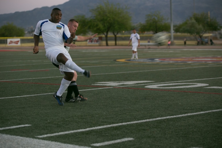 A player with the Headquarters Battalion team kicks the ball during an intramural soccer game against the Marine Corps Communication-Electronics School team at Felix Field aboard Marine Corps Air Ground Combat Center, Twentynine Palms, Calif., May 1, 2017. Marine Corps Community Services, in partnership with Semper Fit, hosts an intramural soccer league for units aboard the installation. HQBN came out victorious with a score of 3-1. (U.S. Marine Corps photo by Cpl. Medina Ayala-Lo)