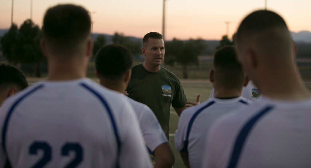 Navy Lt. Richard Schaffer, head coach, Headquarters Battalion soccer team, gives his players pointers during an intramural soccer game against the Marine Corps Communication-Electronics School team at Felix Field aboard Marine Corps Air Ground Combat Center, Twentynine Palms, Calif., May 1, 2017. Marine Corps Community Services, in partnership with Semper Fit, hosts an intramural soccer league for units aboard the installation. HQBN came out victorious with a score of 3-1. (U.S. Marine Corps photo by Cpl. Medina Ayala-Lo)